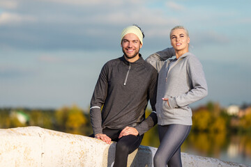 Jogging Concepts. Two Positive Caucasian Runners Athletes Relaxing During Training Together And Smiling As Fitness Exercise Outside While Training Outdoor Process.