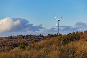 Landscape of a rural region with trees and forest in front of a wind turbine, Baden-Wuerttemberg