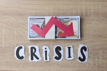 Crisis lettering with red arrow down shape on dollar banknote. Financial crisis concept. 