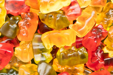 Macro shot assorted colorful gummy candies. Top view candy pattern. Jelly bears background texture.