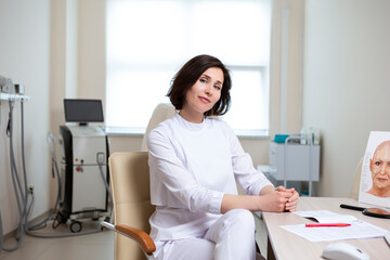 Female Business Concepts. Professional Confident Female Doctor Posing in Doctor's Smock in Laser Rejuvelation Beauty Treatment Salon.