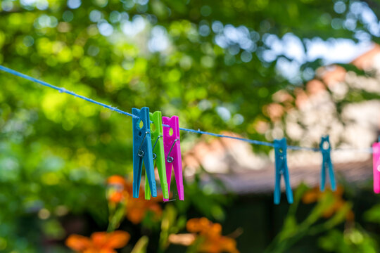 Some colorful clothespins on the clothesline in the garden