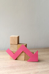 The concept of economic collapse and the collapse of the stock exchange. Wooden blocks and a graph...