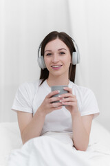Naklejka premium Portrait of Good Healthy woman drinking tea and resting in bed at bedroom. Lifestyle at home concept