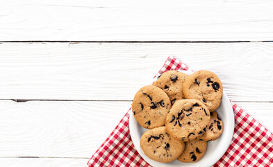 Chocolate chip cookies on a wooden background, flat lay.
