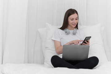 Fototapeta premium Portrait of Good Healthy woman resting and send text to friend by mobile phone in bed at bedroom. Lifestyle at home concept