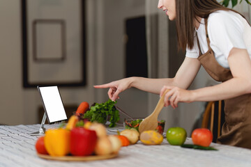 Young Healthy woman cooking healthy food in the kitchen at home. Healthy lifestyle, food, diet concept.