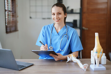 Portrait of a female doctor Center of Excellence from Orthopedic Center are using computers and...