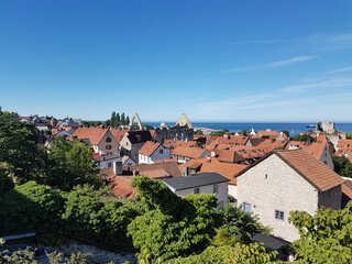 Fototapeta na wymiar Rooftops and medieval ruins on a summer day in Visby, Sweden