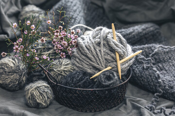 Close-up, gray threads for knitting, yarn with wooden knitting needles.