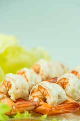 Pile of boiled peeled shrimp place on fresh lettuce and selective focus