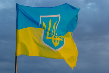 National flag of Ukraine against blue sky, The wind blows out