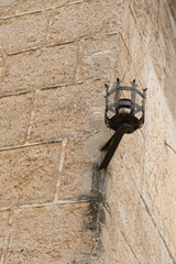 Antique wrought iron outdoor chandelier in a castle in the town of Mura, Barcelona