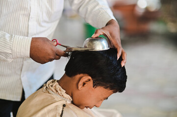 hairdresser cutting hair for Boy in  Hindu ceremony. Upanayana Ceremony. Maharashtra Culture and...