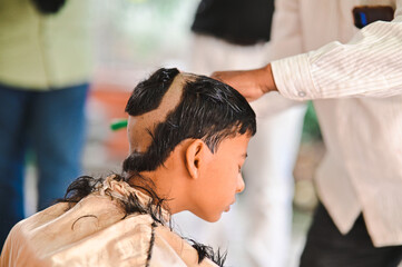 hairdresser cutting hair for Boy in  Hindu ceremony. Upanayana Ceremony. Maharashtra Culture and Rituals. Maharashtra Traditional and Religion Style Cutting for Boy