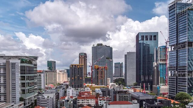 Large white clouds move above downtown Singapore skyline. Time lapse.