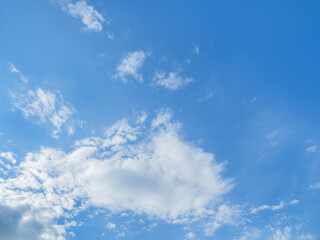 Obraz premium Bottom view on blue sky with fluffy clouds. Sunny day with good weather. Natural background.