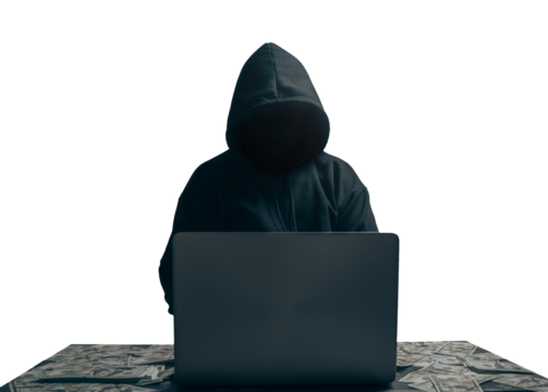 anonymous young man hacker sitting playing laptop with lots of money lying around.Concept Massive financial theft transparent background. png.file