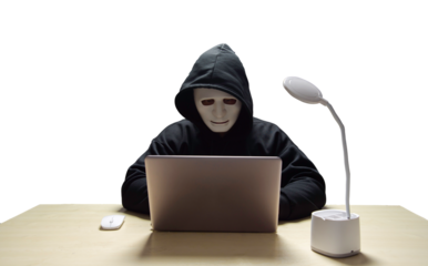 anonymous young man hacker sitting playing laptop with lots of money lying around.Concept Massive financial theft transparent background. png.file