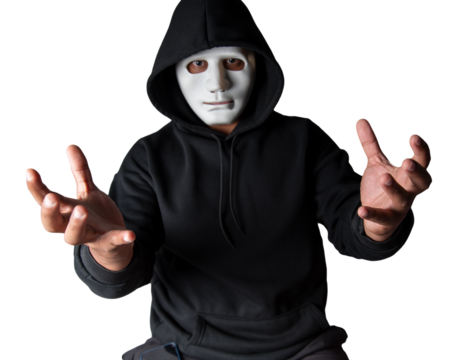 A portrait of an anonymous hacker wearing a mask and a black hoodie sitting with his head tilted and terrifying with clipping path. Hacking and malware concept.