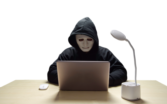 anonymous young man hacker sitting playing laptop with lots of money lying around.Concept Massive financial theft transparent background. png.file