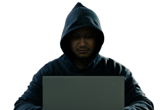 anonymous young man hacker sitting playing laptop with lots of money lying around.Concept Massive financial theft transparent background. png.file