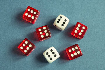 Random number generator. Red and white dice with numerical values lie in a chaotic order.