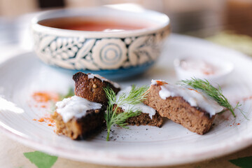 Traditional red Ukrainian borscht with croutons, lard and garlic, sour cream