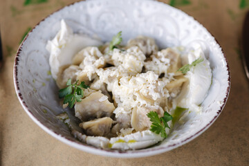 Dumplings with sour cream and butter. Traditional food. 