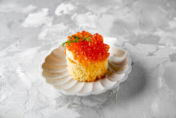 Canape with brioche, butter, salmon red caviar.