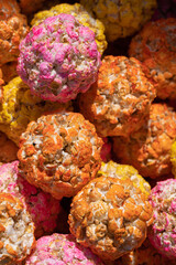 Closeup view of colorful orange pink and yellow popcorn balls on a market stall, Hisor, Tajikistan
