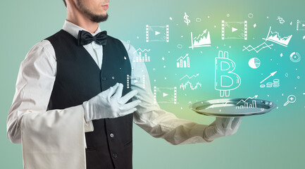 Handsome young waiter in tuxedo holding money icons on tray