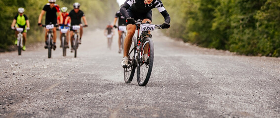 cyclist rider at head of peloton cross-country mountain bike race