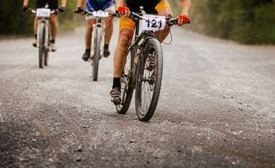 Fototapeta na wymiar three cyclists riders on mountain bikes riding during bike race