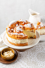 Cake Karpatka. Polish custard Cream puff , sandwiche, cream cake. Consists of two layers of choux pastry decorated with almonds and powdered sugar. Vertical image.
