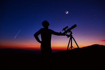 Man with astronomy telescope looking at the night sky, stars, planets, Moon and shooting stars. - obrazy, fototapety, plakaty