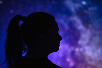Silhouette of a woman with Milky Way starry skies.
