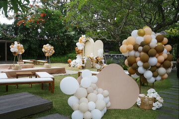 Creative gender neutral baby shower or birthday decoration in the garden. Bohemian style outdoor...