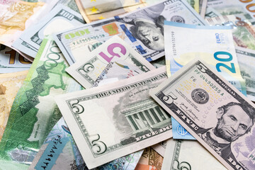 Background from different banknotes of dollars, euros, rubles, Belarusian rubles and other currency. Concept of economic crisis and save money