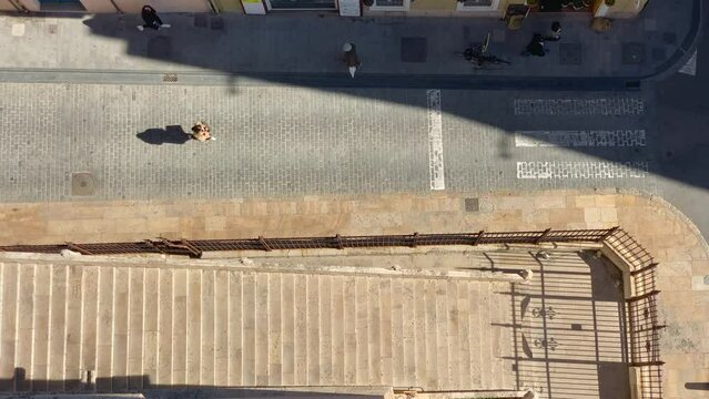 Aerial view of the street and stairs of the Torres de Quart in Valencia, Spain with people walking on a sunny day.