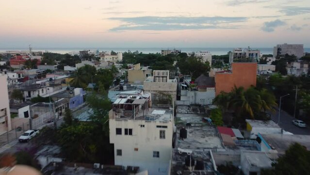 Small mexican town boardering the sea during a sunset, Playa del Carmen