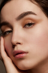 Naklejka premium Purity and tenderness. Close-up portrait of young beautiful girl with shimmer eye shadow makeup. Well-kept healthy skin condition. Concept of natural beauty, skincare, cosmetology, cosmetics, health