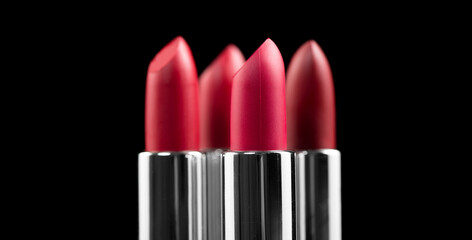 Lipstick. Fashion red Colorful Lipsticks isolated on black background. Red Matte lipstick tints palette, Professional Makeup and beauty. Beautiful Make-up concept. Lipgloss. Lipsticks closeup