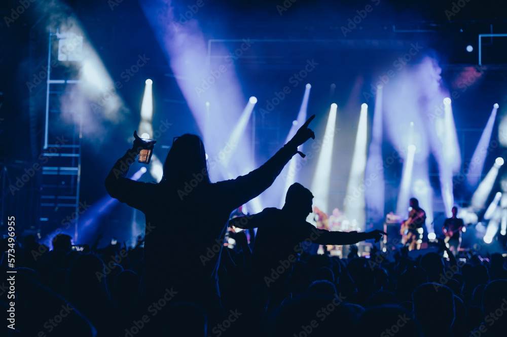 Canvas Prints Silhouette of a woman with raised hands on a concert