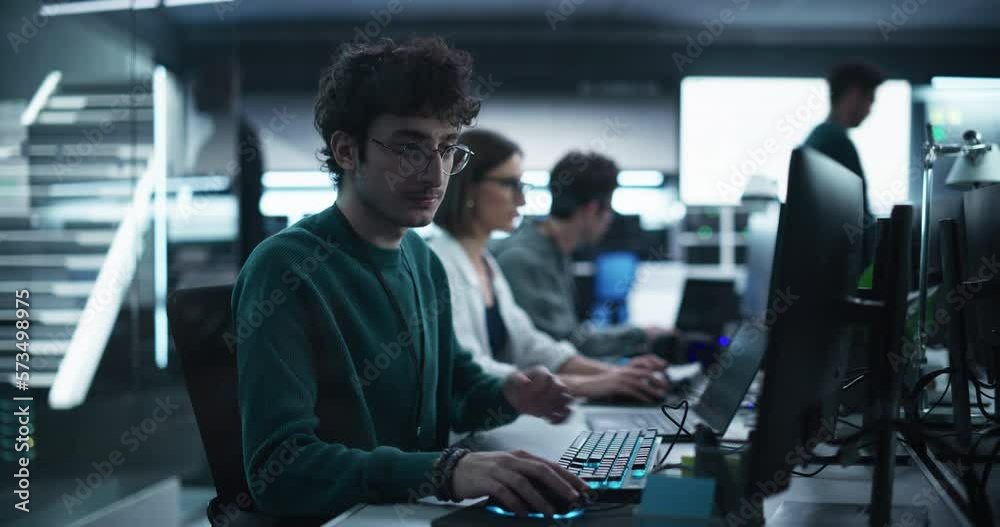 Fototapete Young Handsome Software Developer Working on Computer in a Technological Laboratory Environment. IT Programming Department Tirelessly Researching and Developing Advanced Commercial Internet Products