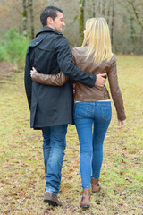 Embracing couple walking in countryside