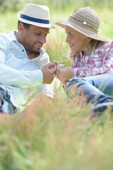 loving couple layed in long grass