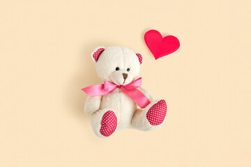 Valentine's Day. Love heart. Teddy Bear and Red Heart on Neutral Beige Color Pastel Background. Vintage Retro Romantic Style. Unusual Creative Greeting Card. Family, Wedding and Friendship. Top View