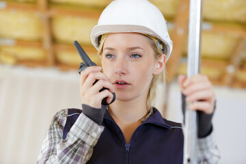 female construction worker using a walkie talkie
