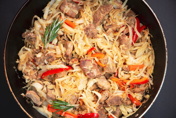 stewed cabbage with meat in a pan